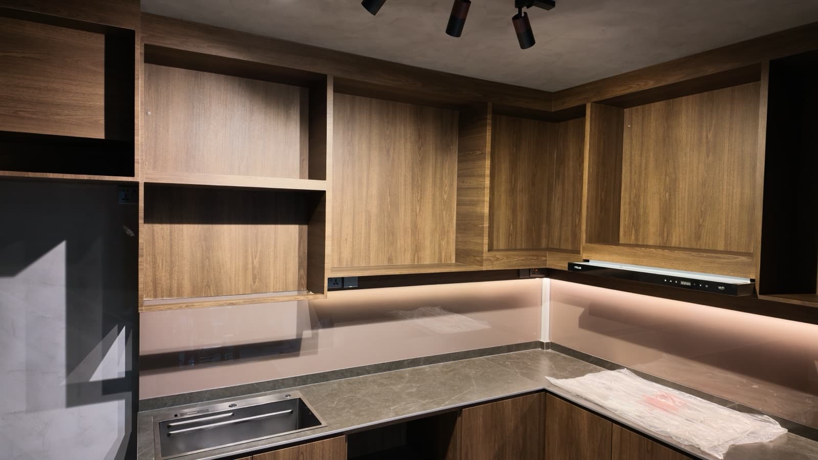 Kitchen cabinets wrapped in premium walnut wood-grain architectural film